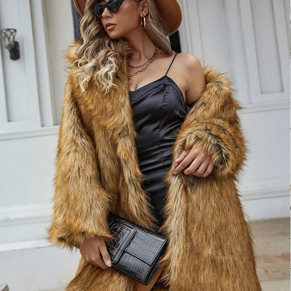 Yellow women's mid-length faux fur coat with a loose fit and regular sleeves on a hanger.