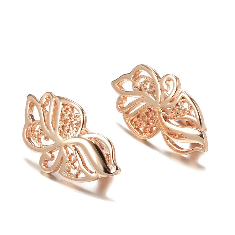 Women's rose gold earrings with hollow carved geometric design and rhinestone accents