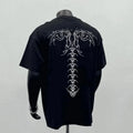 Man wearing a black loose fit pure cotton short sleeve tee shirt with a print design.