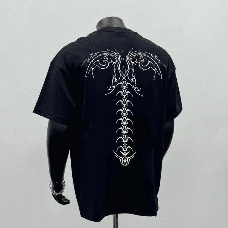 Man wearing a black loose fit pure cotton short sleeve tee shirt with a print design.