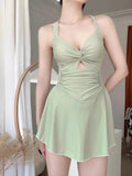 Women's one-piece boxer swimsuit in avocado green, backless design, on a white background.