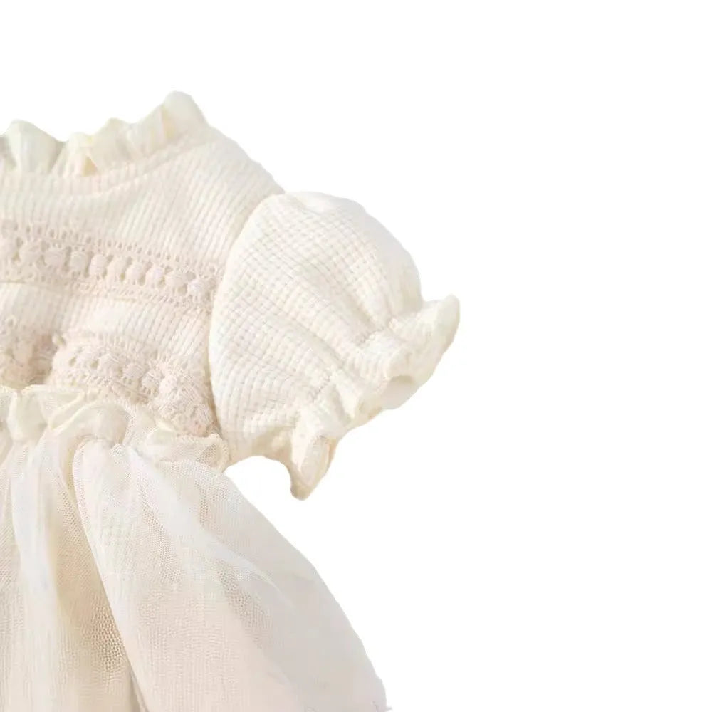 Apricot cotton triangle jumpsuit for girls with short sleeves and single-breasted closure on a white background
