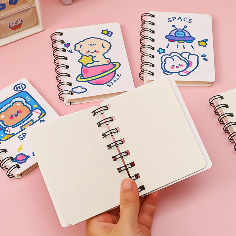 Astronaut themed pocket flipper notebook showing 10.5 by 8 cm dimensions with space cat cover design