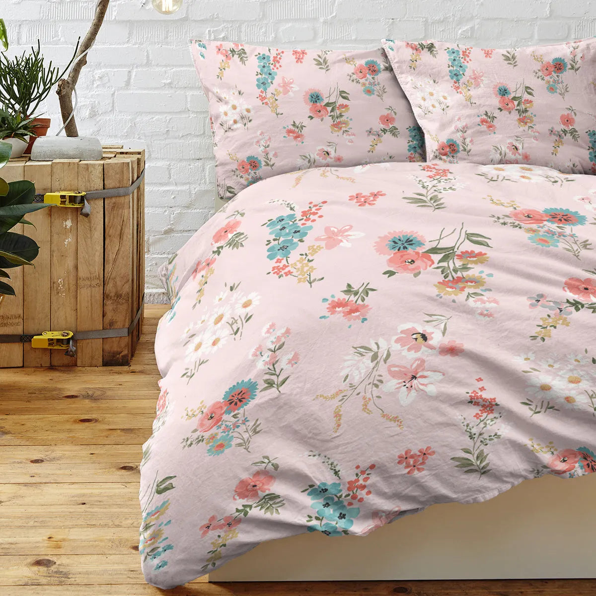 Pink floral microfiber duvet set with two pillow shams on a bed