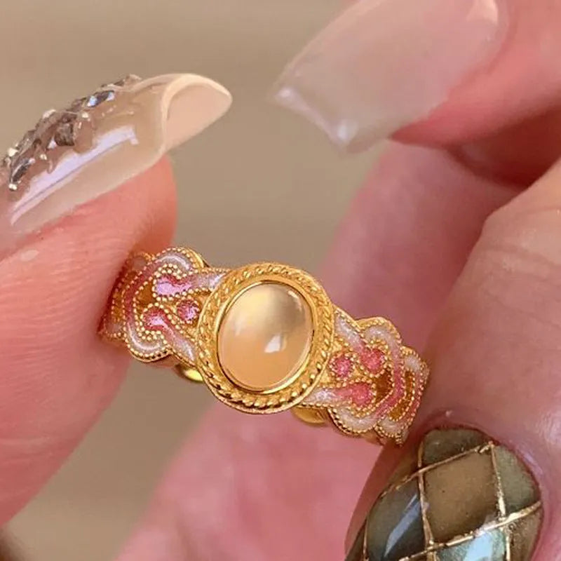 Pink crystal enamel geometric open mouth ring on a gold-plated copper band.