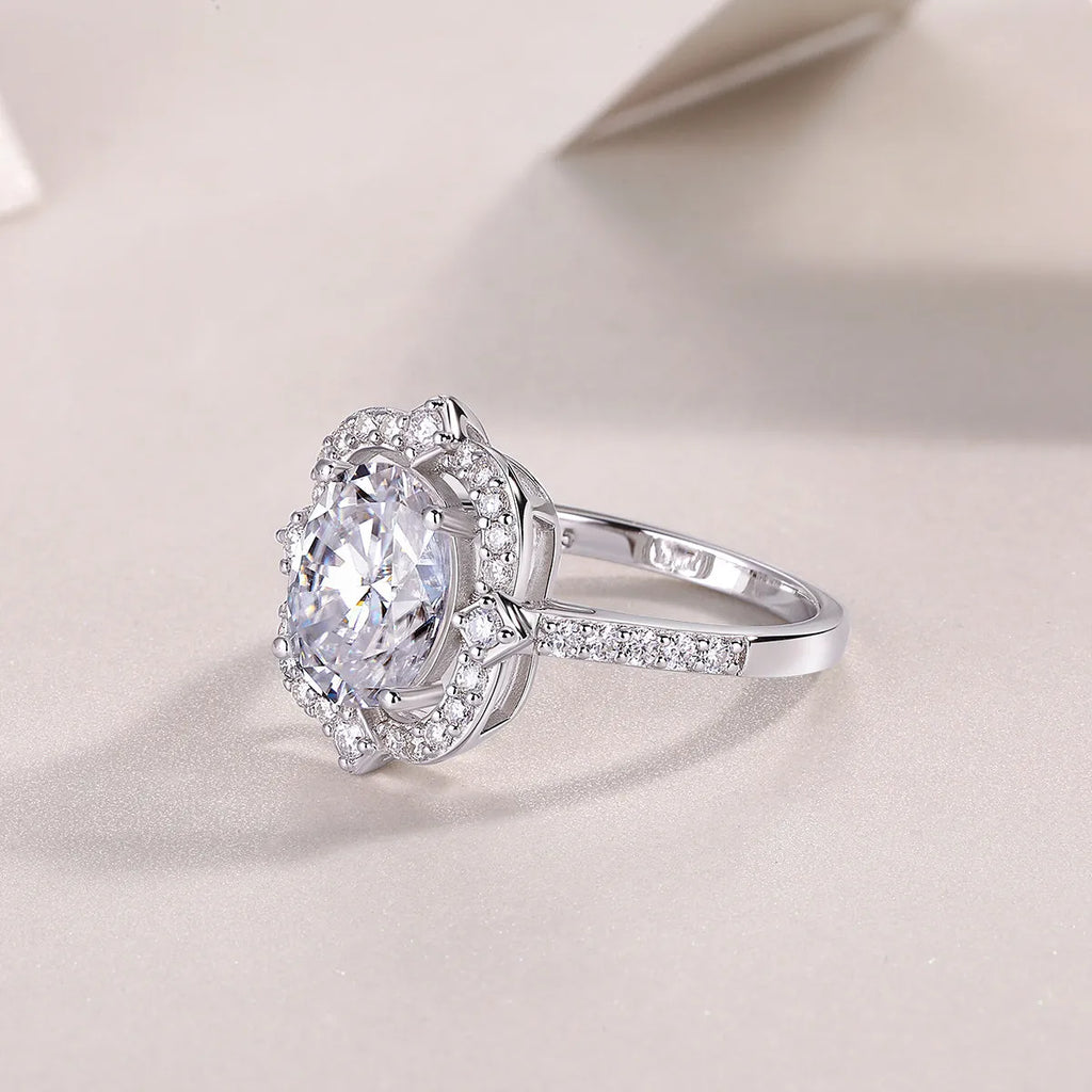 Egg-shaped moissanite ring set with S925 silver and platinum plating on a white surface