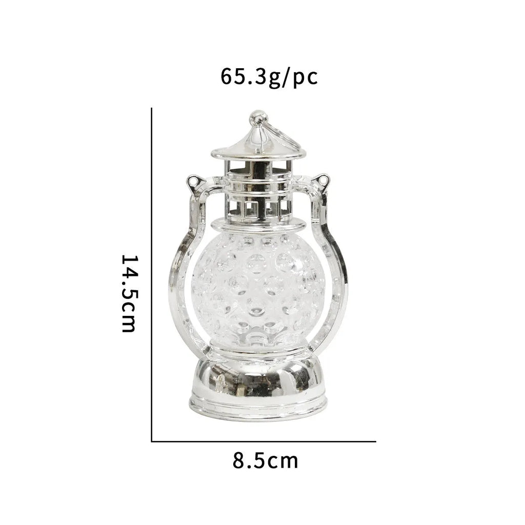 Creative retro-style oil lamp LED night light in gold or silver finish on a dark surface