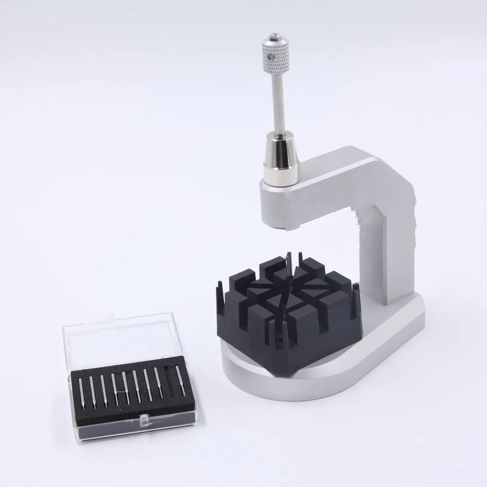 Silver tool steel multi-purpose press strap and pin removal tool on a work surface.