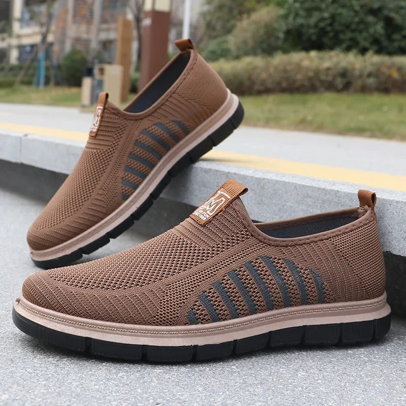 Slip-on soft bottom casual sneakers for men in black with mesh upper and low-top design