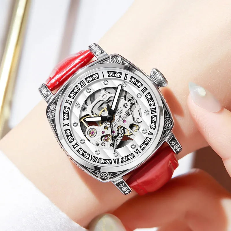 Mechanical watch with luminous hands and a brown leather strap, showing white dial.