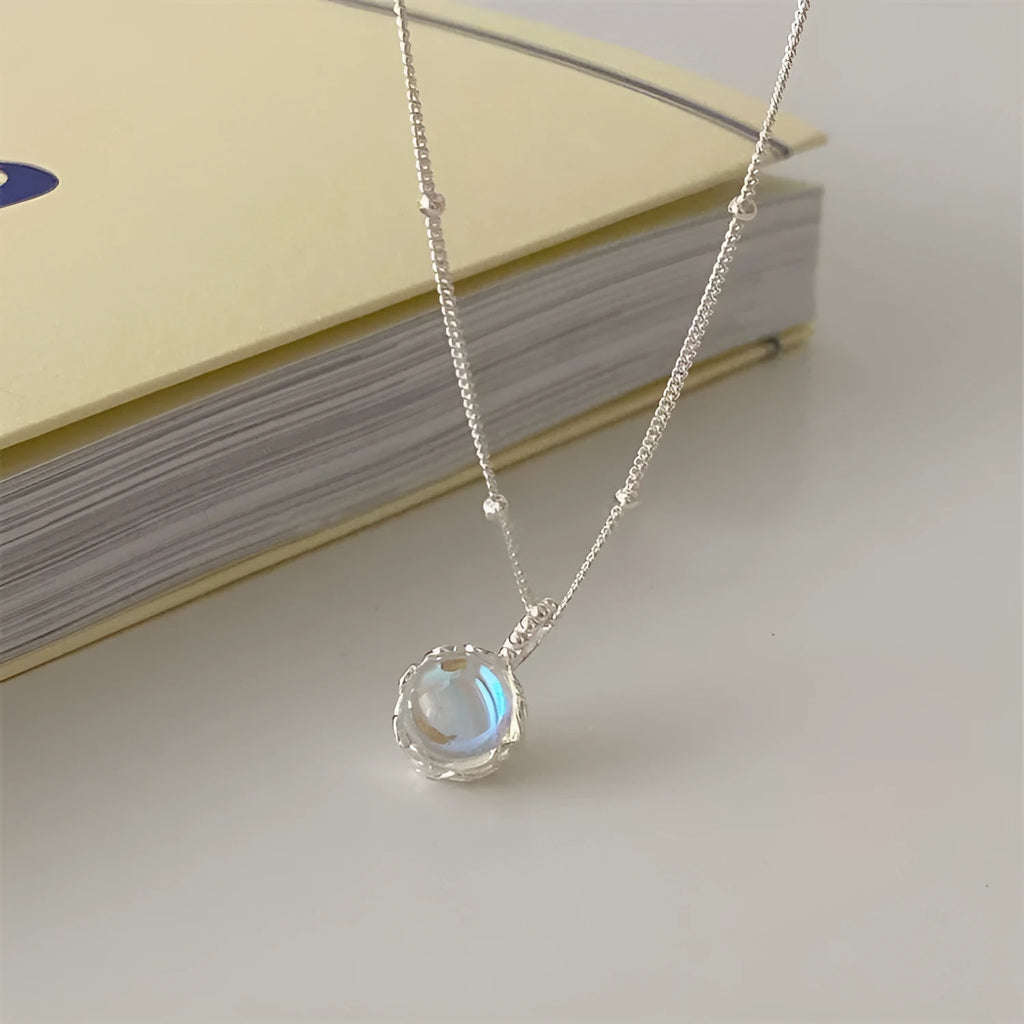 Geometric silver pendant on an adjustable 925 silver curb chain necklace.