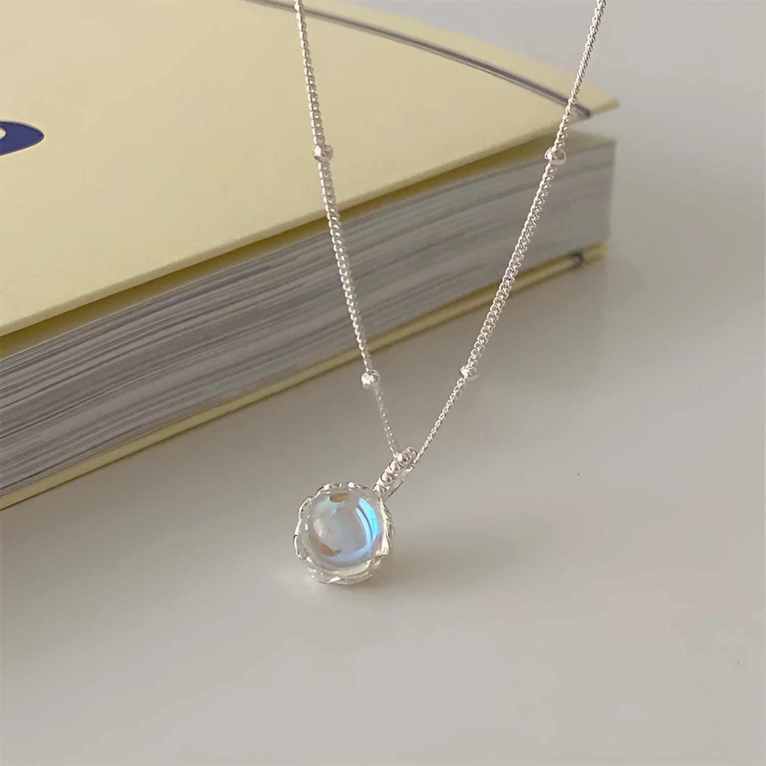 Geometric silver pendant on an adjustable 925 silver curb chain necklace.