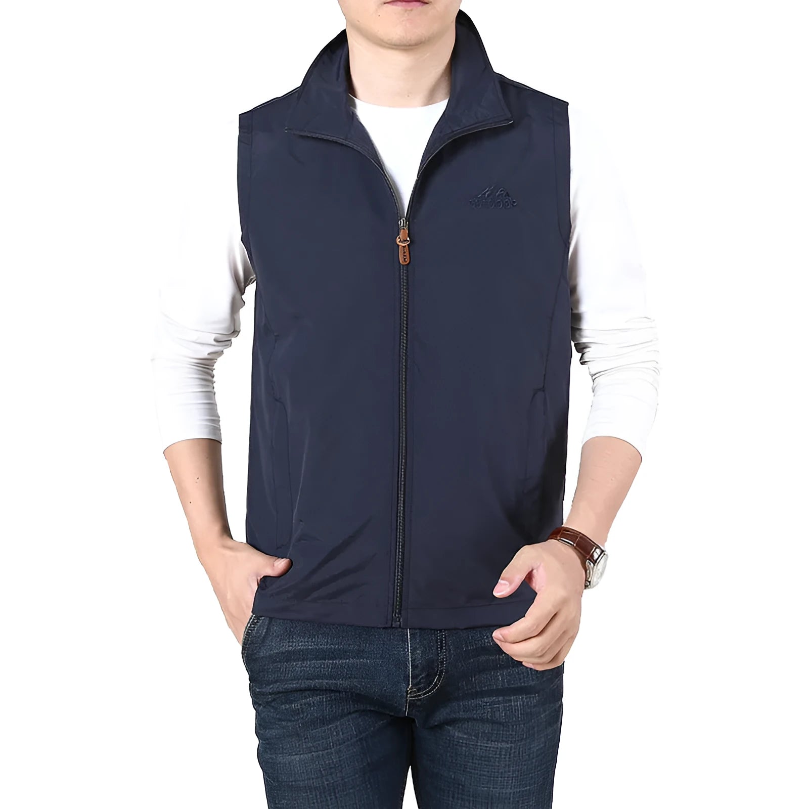 A man wearing a thin khaki coloured waistcoat vest with side seam pockets, shown in a casual setting.