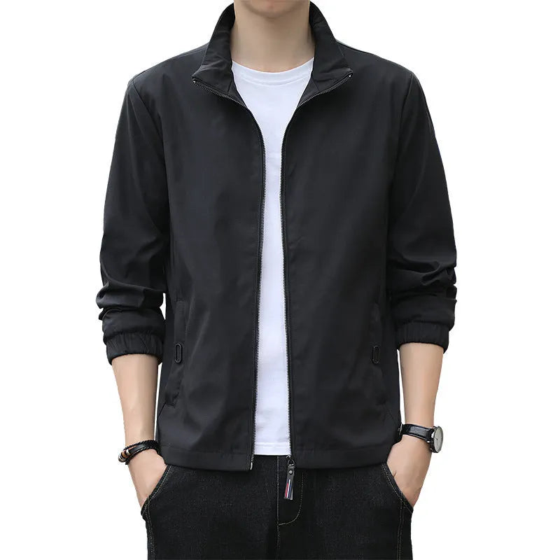 Man wearing a loose-fit black lapel collar casual jacket, Korean style, with zippered pockets.