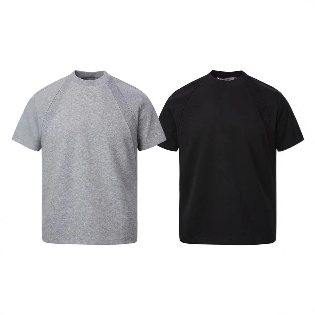 Man wearing a loose grey short sleeve top with visible air layer texture stitching on the front.