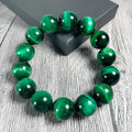 Green tiger eye stone geometric bead bracelet shown in different size options on a wrist.