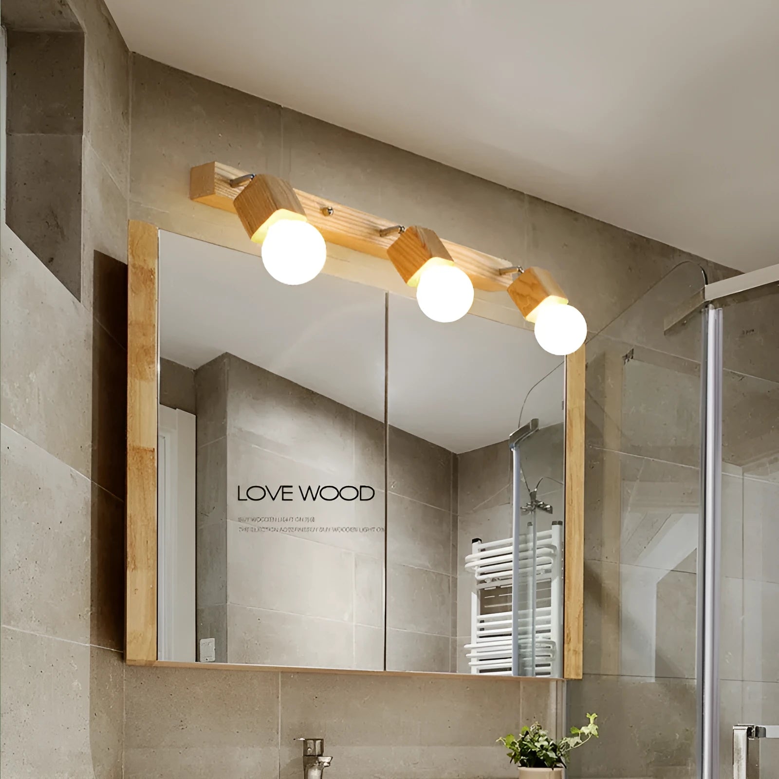 A narrow 24cm wide mirror-finish LED wall lamp with a single light head.