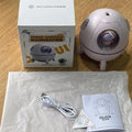 Astronaut-shaped USB desktop humidifier with colourful LED light on a desk.