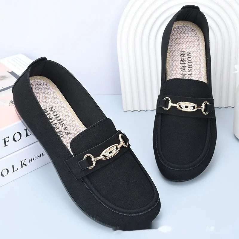 Gommino women's black casual slip-on shoes with round toe and flat rubber sole on a white background.