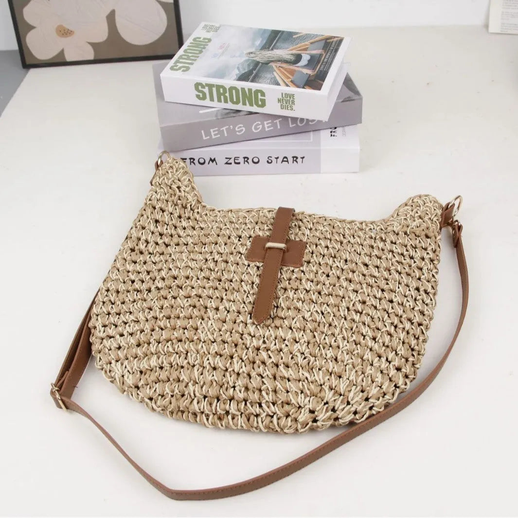Beige handmade woven bag with a special-interest design and a long shoulder strap.
