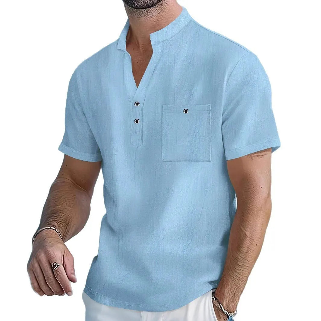 Man wearing a light-coloured linen blend stand collar t-shirt with short sleeves.