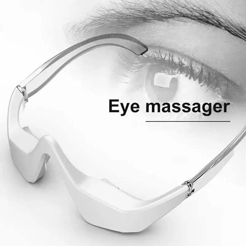 Pink and white micro-current eye massager with glasses-style frame on a grey background.