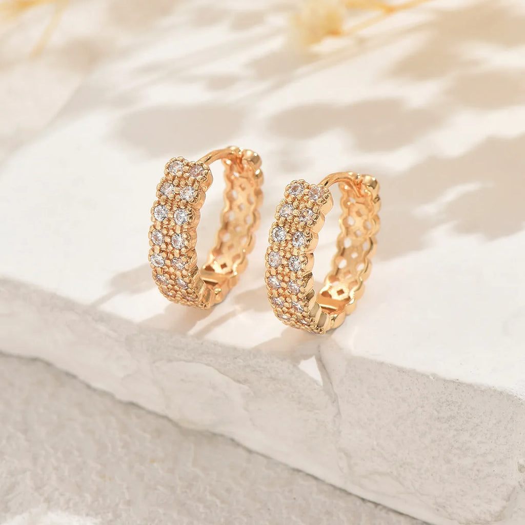 Copper geometry pattern ear studs with round, dot, and ring elements.