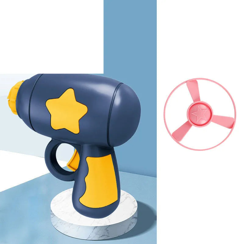 Plastic flying saucer launcher toy set with LED lights and coloured discs on outdoor grass.