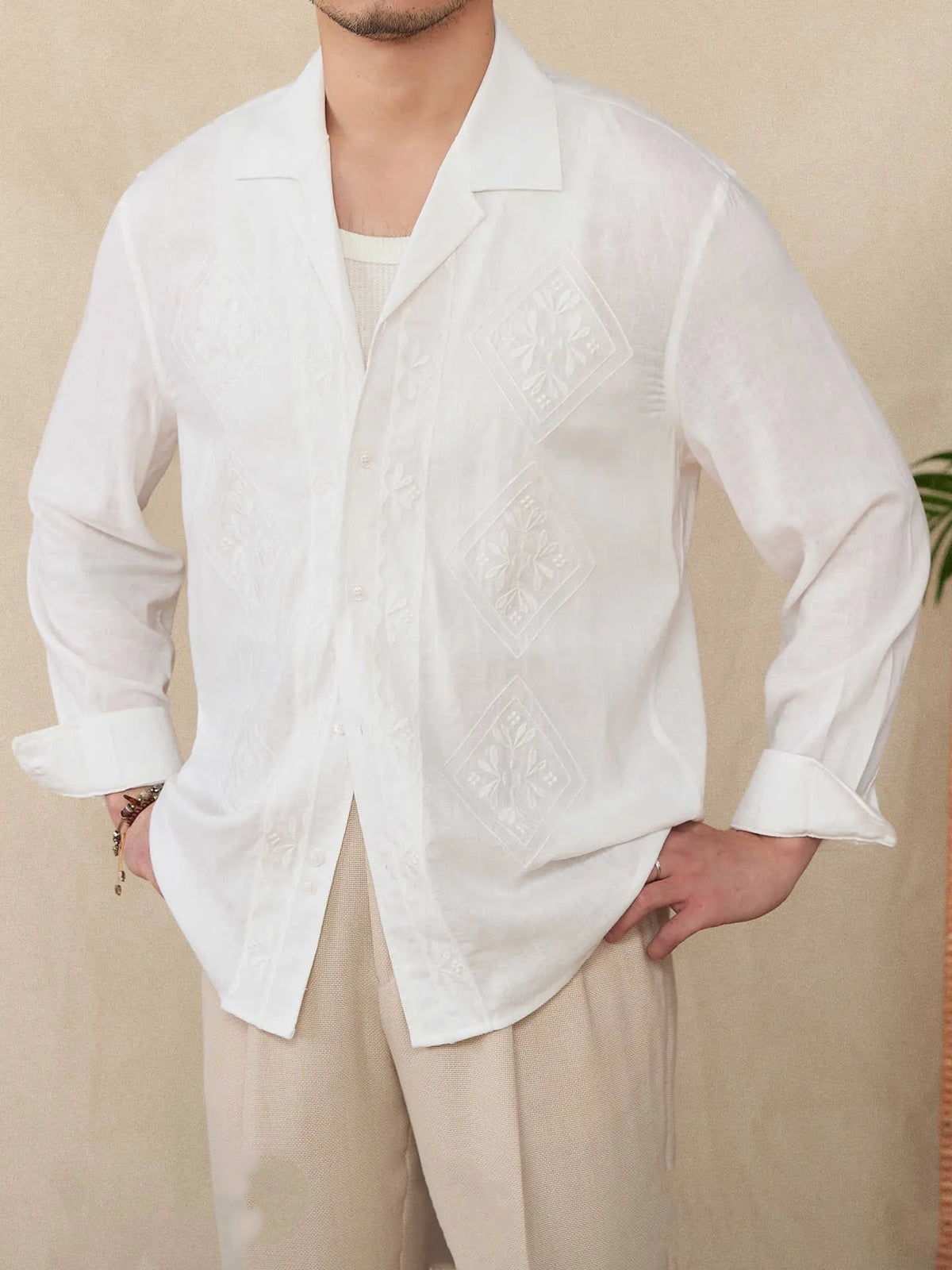 Cotton and linen thin embroidery Cuban collar long sleeve sunscreen shirt in white on a plain background