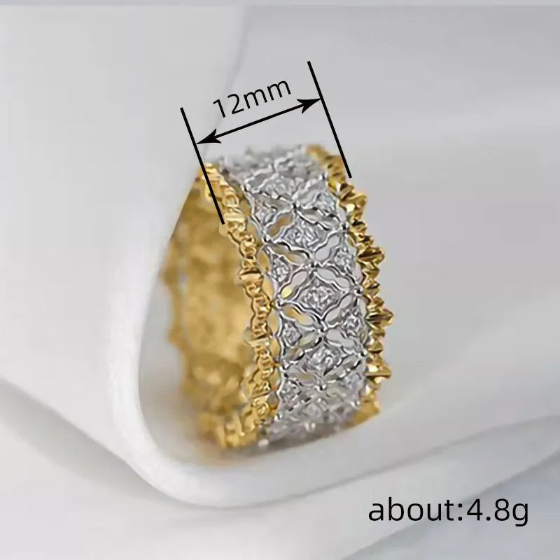 Geometric two-tone gold zircon ring with a round stone on a copper band.