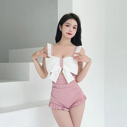 Women's one-piece swimsuit with adjustable bow detailing in solid colour