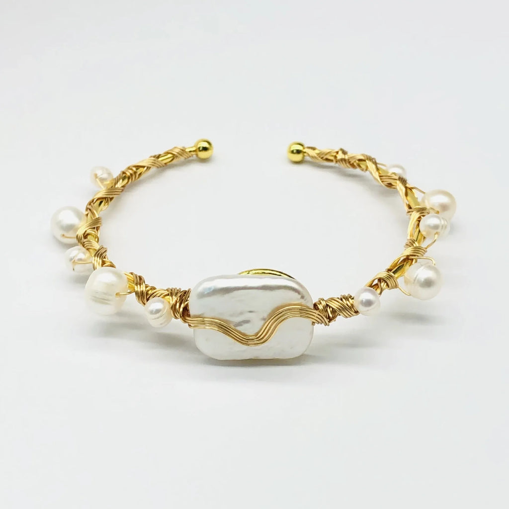 Natural freshwater pearl bracelet with gold titanium steel wire-wrap on hand model