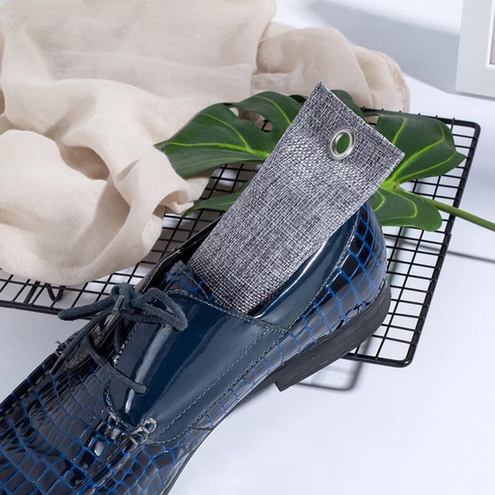 Four bamboo charcoal deodorising bags in black, green, grey and blue colours measuring 16.5cm x 6.5cm