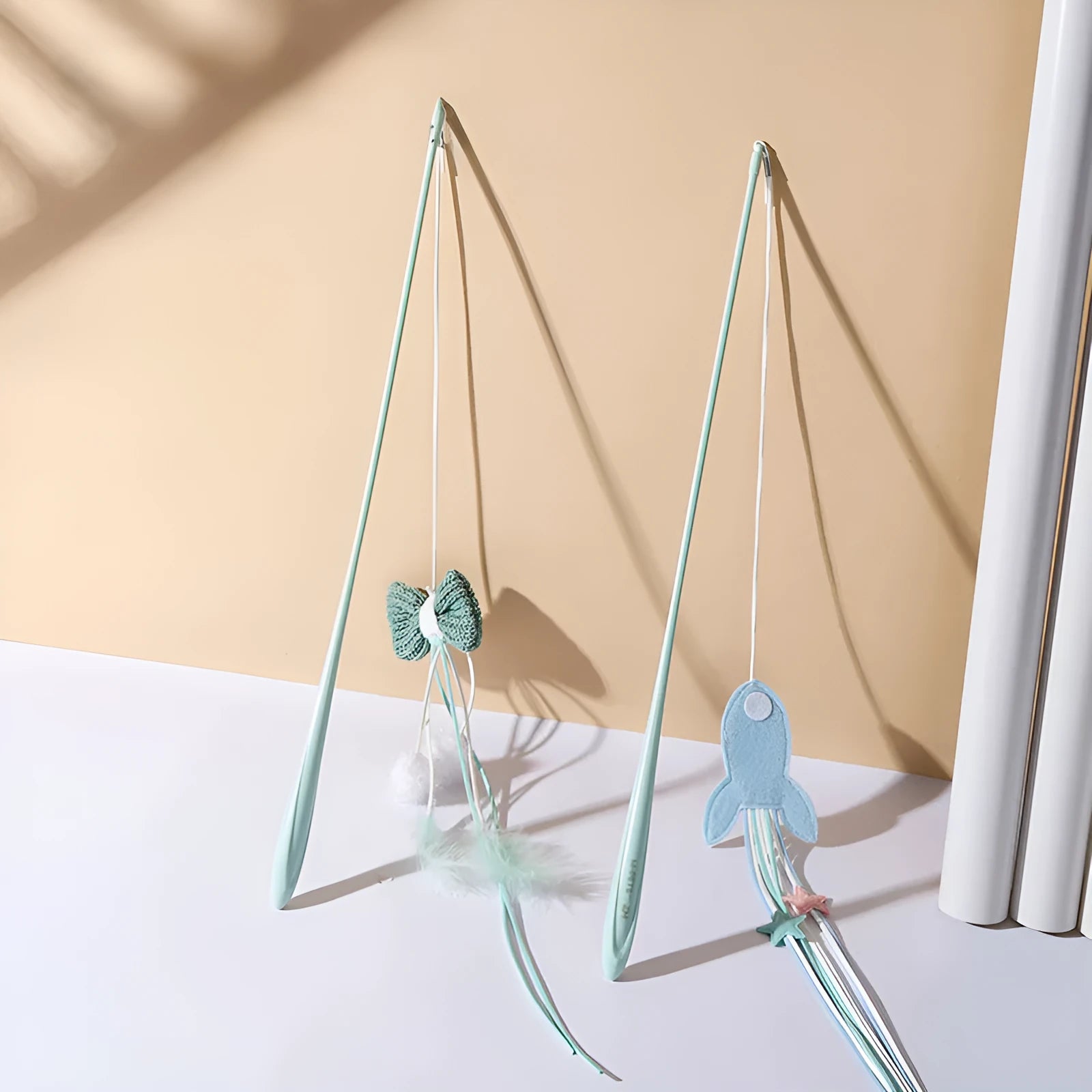 Blue cat teasing toy with long pole, feathered rocket head, and bite-resistant construction.