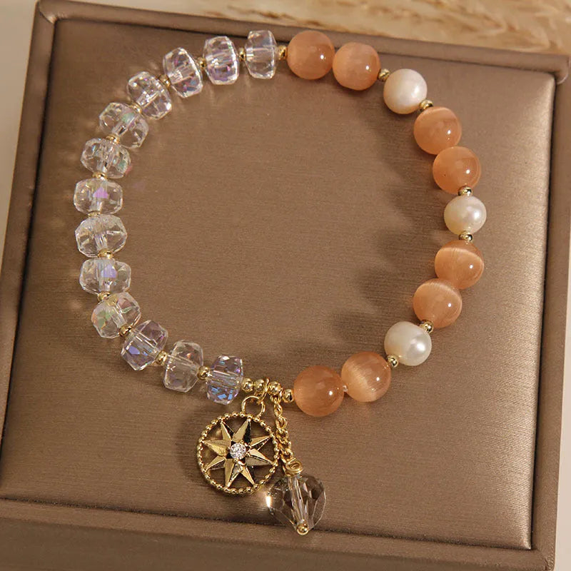 Orange eight Awn star bracelet with gold-plated inlaid gemstones showing detailed design