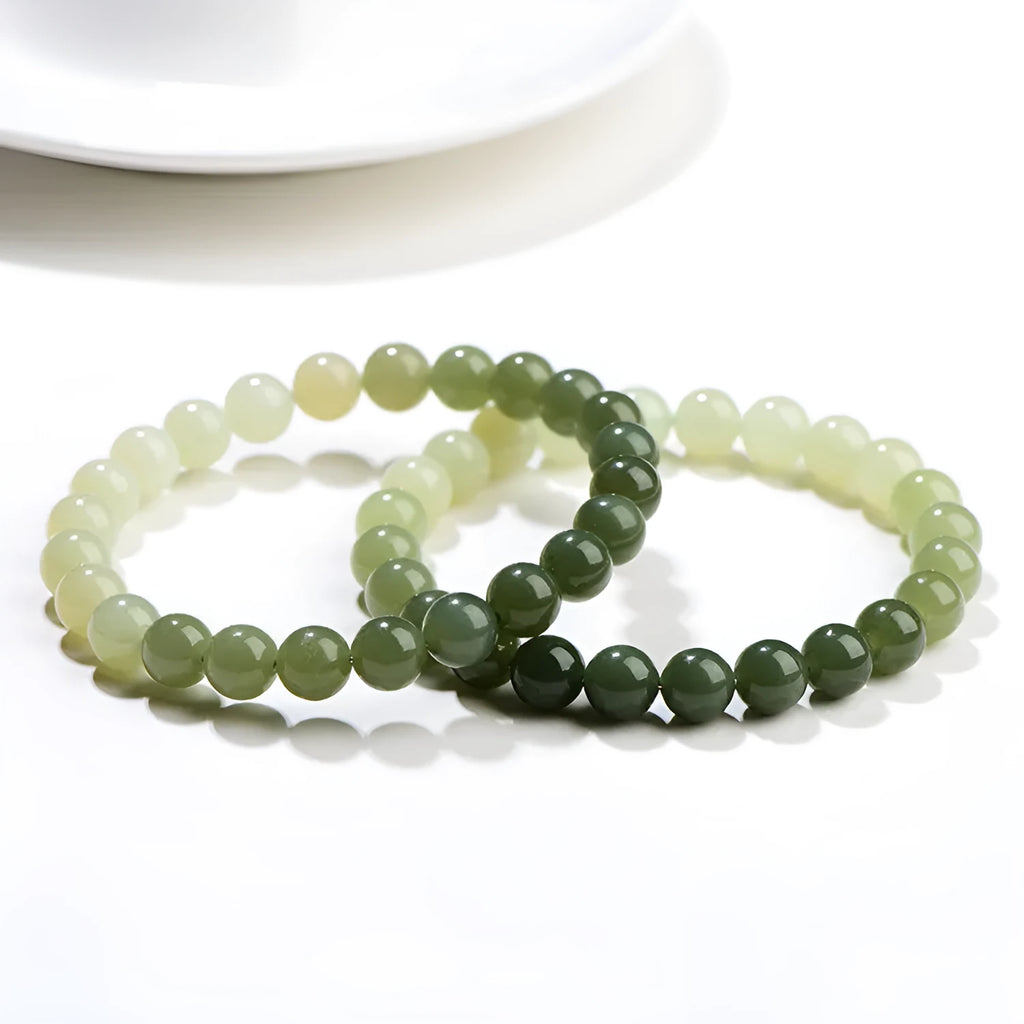 Natural Hetian jade bracelet with gradient water colour round beads on a wrist