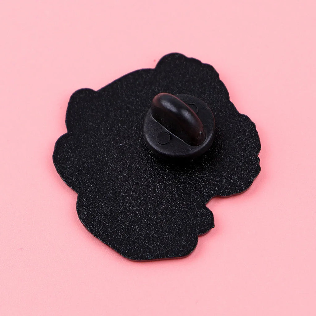 Cat shaped alloy brooch with dripping oil finish on a neutral background showing the pin clasp.