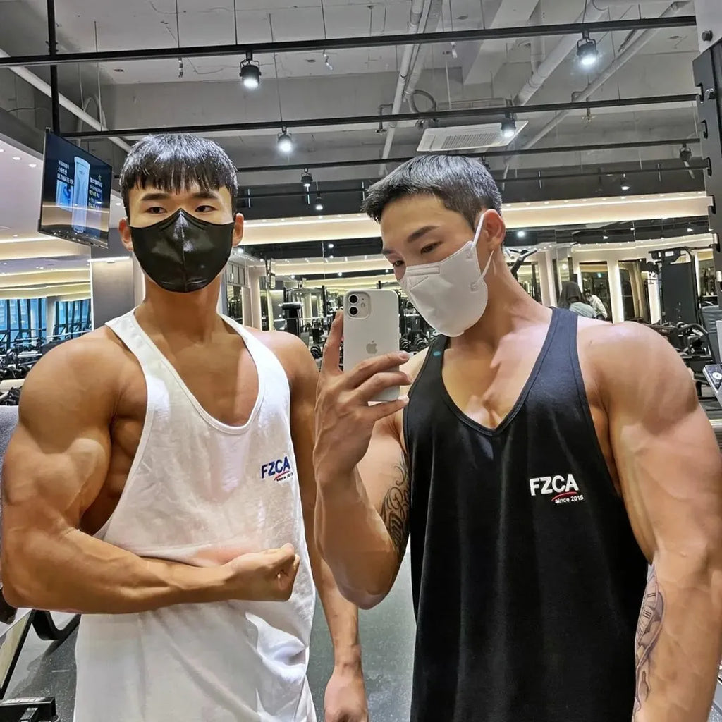 Men's white cotton sports vest for fitness and running training, shown on a hanger.