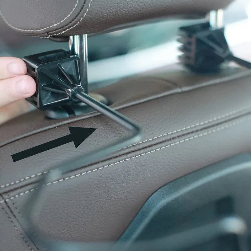 Black metal snap-on hat bracket mounted on a car rearview mirror