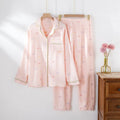 Beige and pink women's long-sleeved cotton pajama set with trousers on hanger.