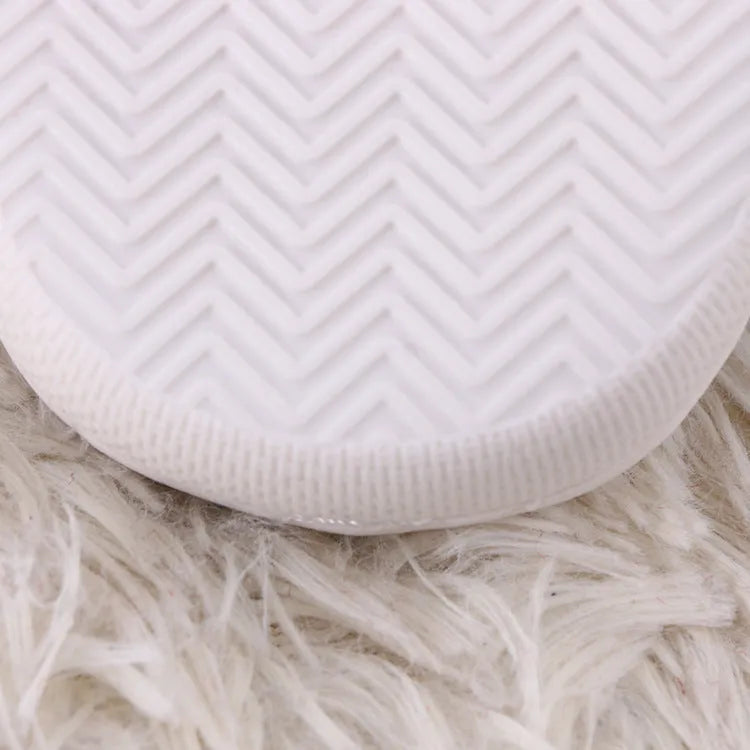 White cartoon pattern fluffy slippers with a plush upper and a non-slip rubber sole.