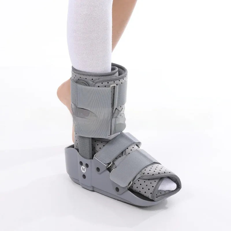 Grey and black adjustable Achilles tendon rehabilitation walking boot with plastic shell and straps.