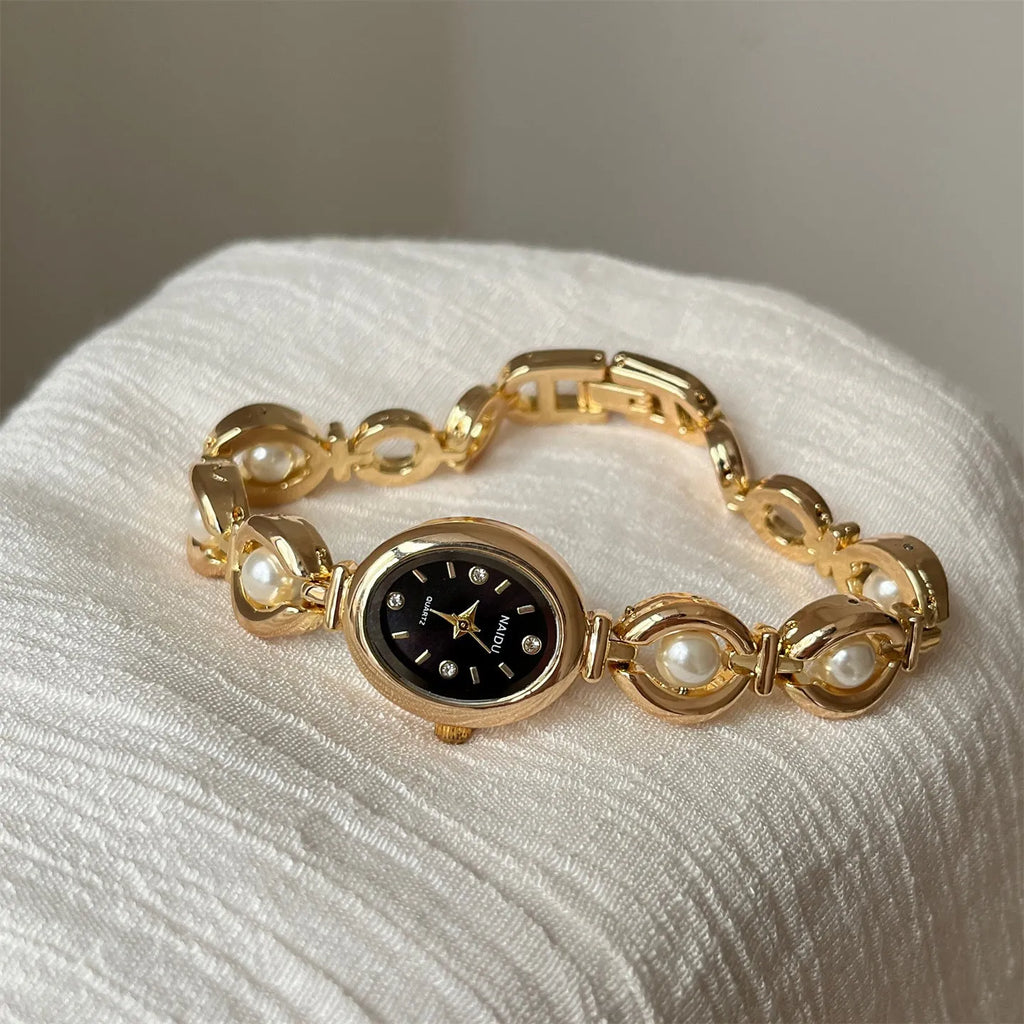 Women's quartz watch with alloy bracelet and pointer display, gold strap black surface