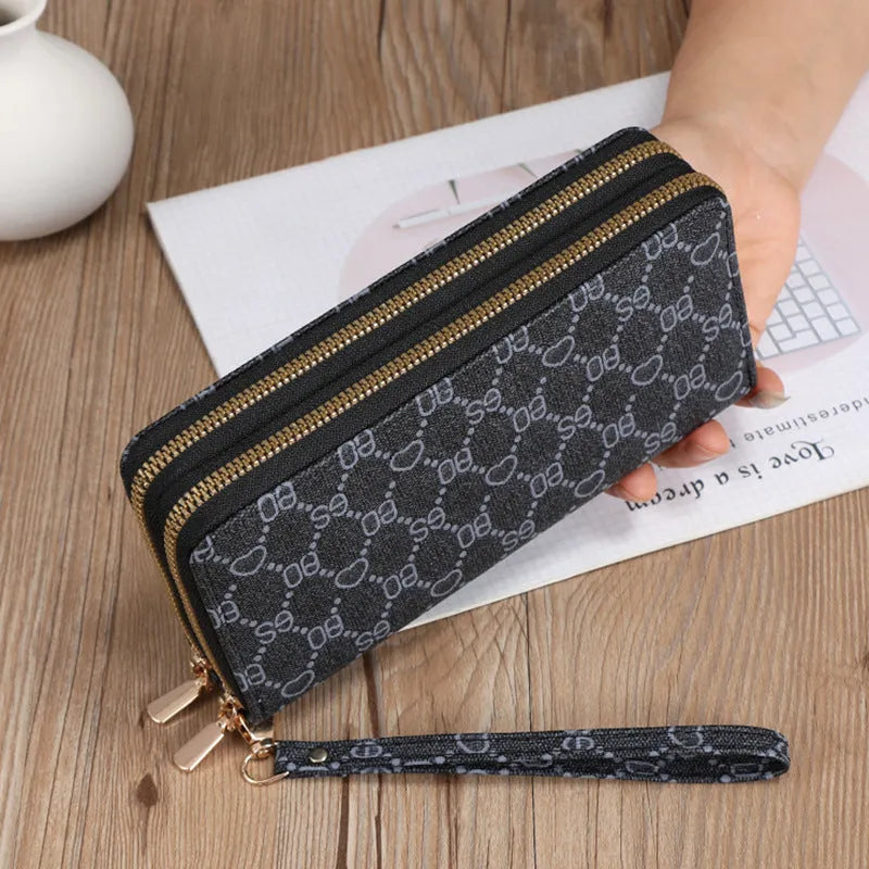 Long black PU leather wallet clutch with print detail showing mobile phone compartment and coin purse
