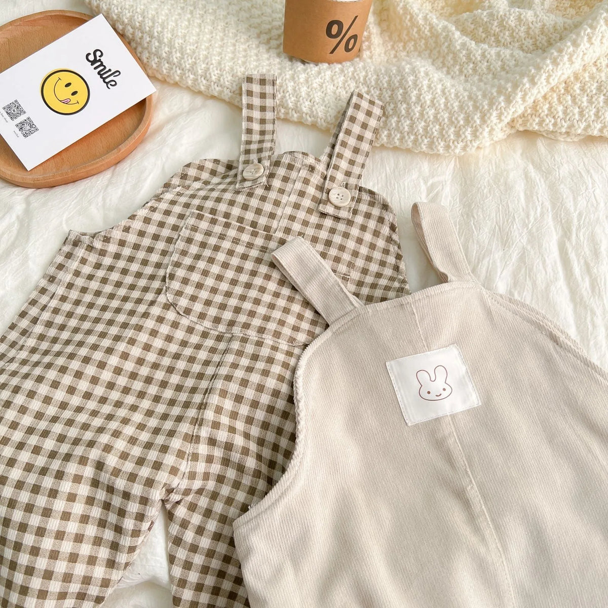 Infant plaid corduroy overalls in creamy-white with large pockets and double breasted closure