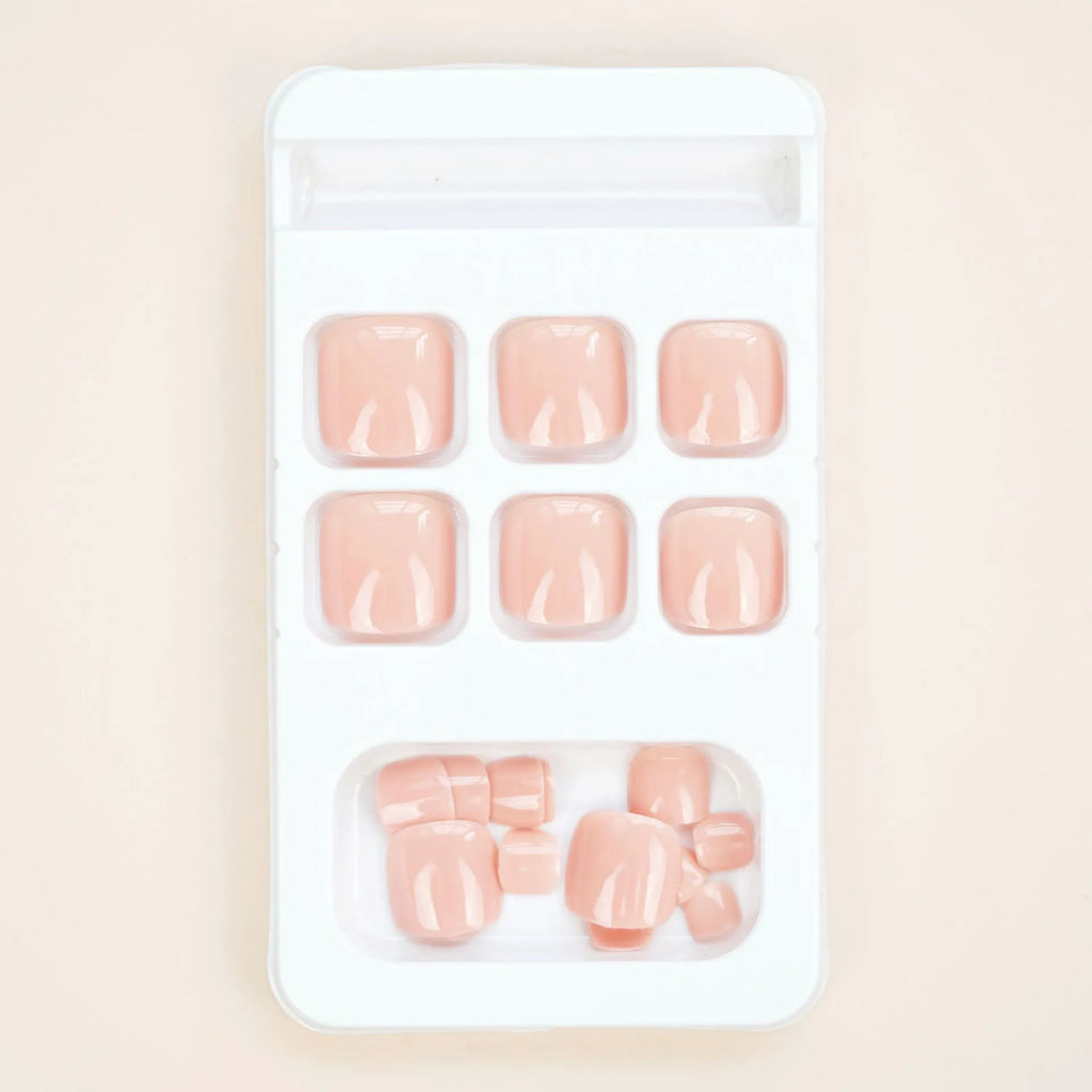 Finished plastic toenail stickers in skin colour with glue bottle, presented on a card.