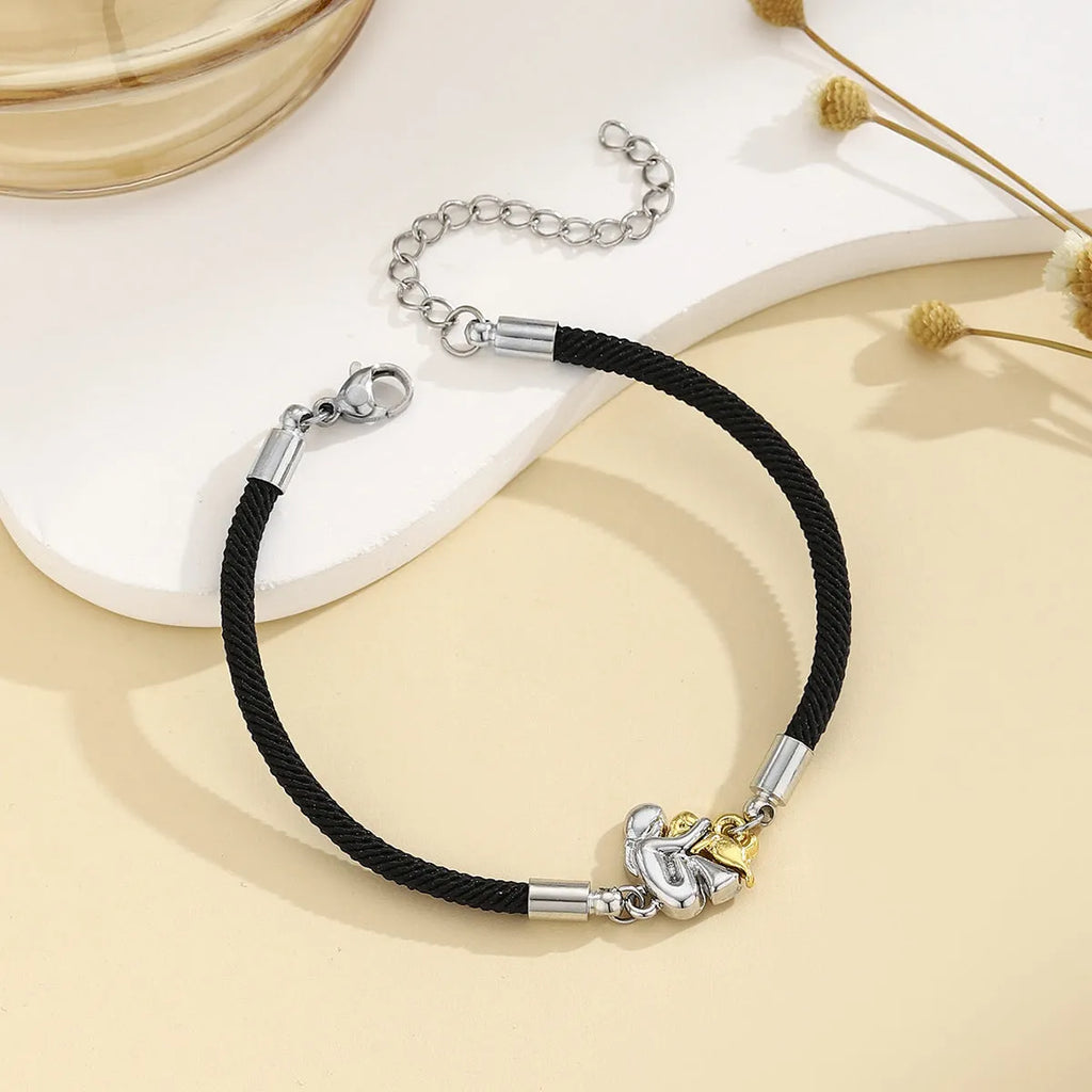 Woven black flexible wire couple bracelet with angel element and electroplated finish