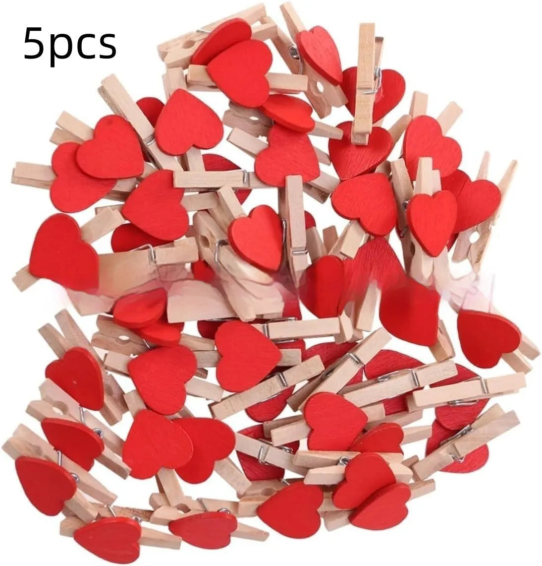 Set of five small red, pink, and white solid wood heart-shaped clips on a surface.