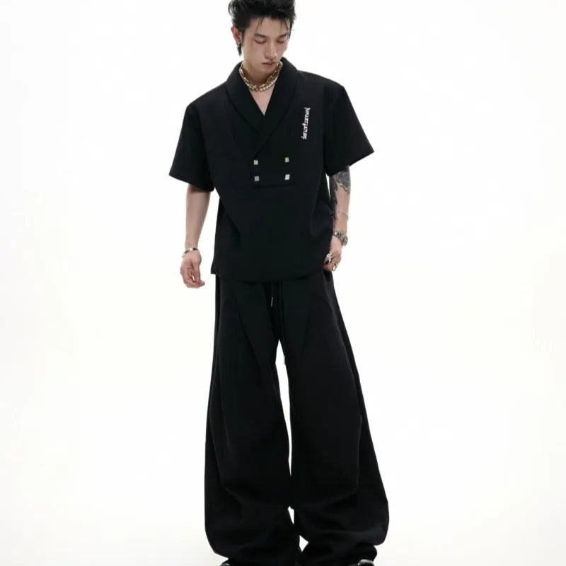 Men's dark grey V-neck cotton sports suit with padded shoulder jacket and matching shorts.