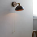 Nordic style wooden wall mounted bedside lamp in a bedroom setting